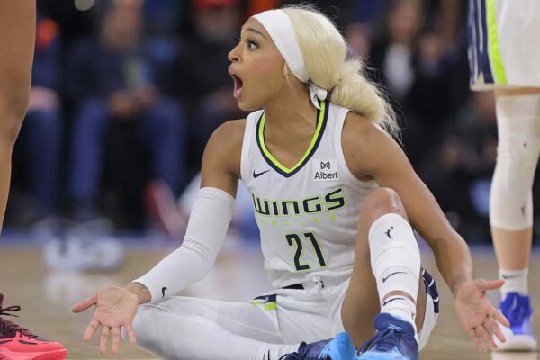 DiJonai Carrington pushes back after referees call security during Wings game